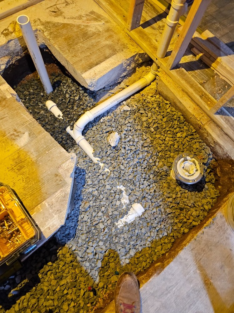 PVC drainage rough-in with gravel bed for ground-floor bathroom