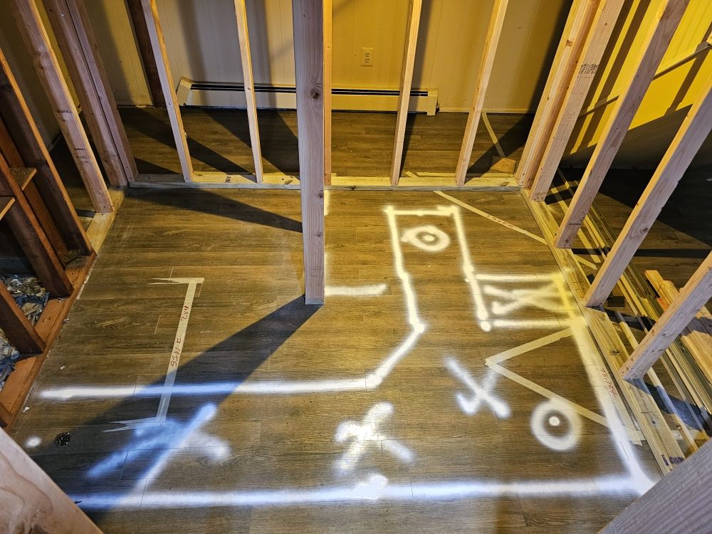 Bathroom rough-in floor with marked plumbing layout