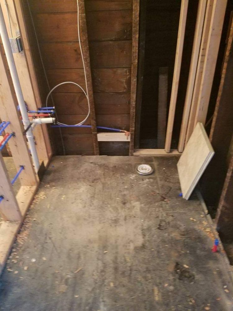 Bathroom under construction with PEX rough-in and framing