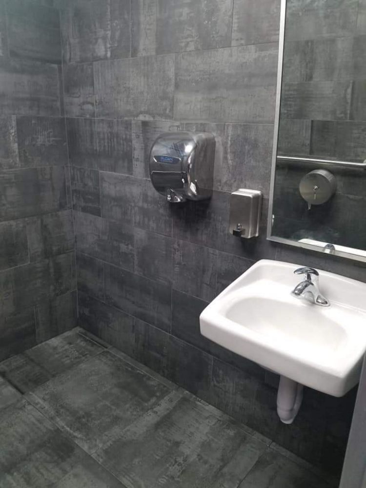 Modern grey-tile commercial bathroom
