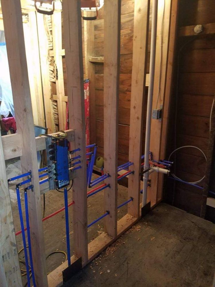PEX rough-in plumbing manifold with blue and red lines